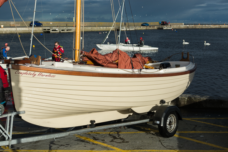 This boat, with its burnt orange sail, stood out among its peers while out at see. Not quite so resplendant after being hauled ashore. In fact, "Completely Harmless"! 